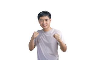 Young handsome man wearing casual t-shirt over white background. Punching fist to fight, aggressive and angry attack, threat and violence, looking forward in boxing fists and ready to attack. photo