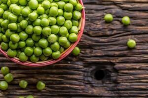 Peas. Fresh bio homemade peas and pods on old oak board. Healthy fresh green vegetable - peas and pods. photo