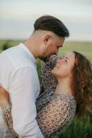 Couple in love on green field of wheat photo