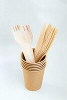 Cardboard disposable cup for coffee. Eco friendly food containers from paper. Spoons and knifes. Plastic free. photo