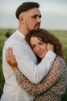 Couple in love on green field of wheat photo