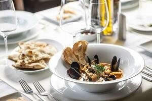 Seafood and fish soup served in an Italian restaurant in a fancy setting photo
