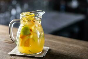 Fresh lemonade with various citruses in a full jar with fresh wedges of fruit inside photo