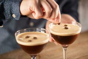 Espresso martini vodka short drink as a coffee cocktail inclduing coffee liqueur and vanilla syrup photo