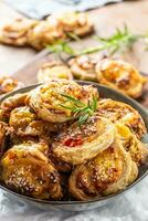 Pizza rolls stuffed with various ingredients, prosciutto bacon spinach basil mozzarella or parmesan cheese photo