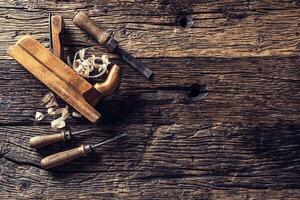 Top of view old planer and other vintage carpenter tools in a carpentry workshop photo