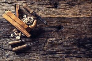 Top of view old planer and other vintage carpenter tools in a carpentry workshop photo