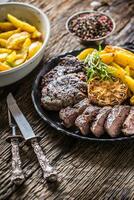 Grilled beef Rib Eye steak with garlic american potatoes rosemary salt and spices photo