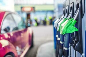 Close-up fuel nozzles on petrol and diesel fuel photo