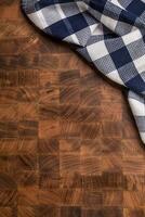 Top  of view checkered tablecloth on empty wooden butcher board photo