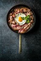 Top of view roasted bacon and egg with herbs. photo