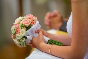 Wedding bouquet. Bride holding her wedding bouquet with roses photo