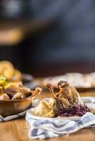 Roasted christmas duck leg red cabbage dumplings liver draft beer and baked buns photo