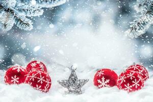 Red christmas balls on snow with fir branches photo