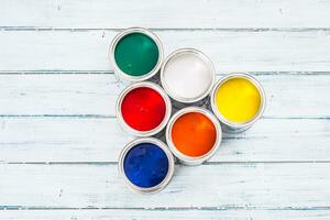 Top of view full of multicolored paint cans on table. photo