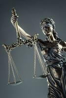 Statute of Justice. Bronze statue Lady Justice holding scales and sword photo