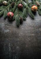 Top of view christmas decorations jingle bells fir tree pine cones on free concrete background photo