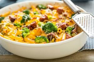 Baked pasta penne with broccoli smoked pork neck mozzarela cheese and othe ingredients photo