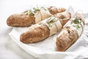 Soft and crunchy baguettes from wholgrain flour on a white background photo