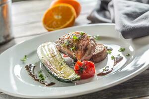 Roasted duck breast with zucchini tomato and parsley herbs photo