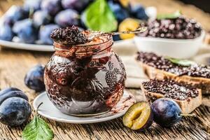 Breakfast from homemade plum jam bread and ripe plums. photo