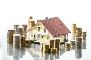 Model familly house with coins as bank or insurance concept photo