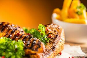 Grill chicken breast salt pepper parsley herbs and french potato fries photo