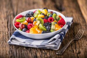 Fruit fresh mixed tropical fruit salad. Bowl of healthy fresh fruit salad - died and fitness concept. photo