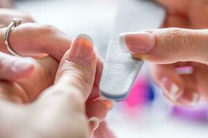 Close-up manicure of female nails in nail salon photo