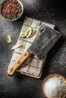 Old meat butcher on dark concrete board photo