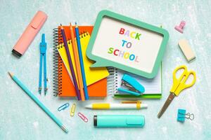 Top view of notebooks and school supplies with speech bubble with the text Back to school. Back to school concept photo