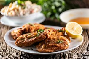 Fried steaks and potato salad, a traditional dish served for the Christmas or Easter holidays photo