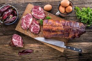 Pork meat.Pork chop smoked. Traditional smoked meat on oak wooden table in other positions photo