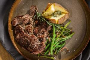 Beef steak with green beans rosemary and potatoes. photo