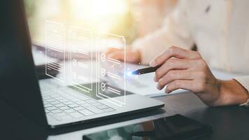 Businessman checking the steps through a virtual online document with a list of checkboxes Concepts of practices and policies, company articles of association Terms and Conditions photo