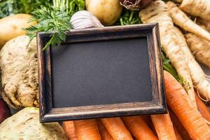 Top of view empty chalkboard on fresh vegetables photo