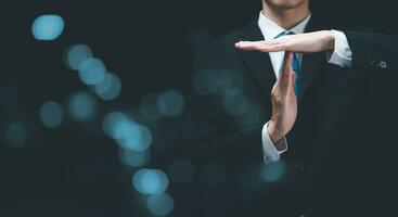 Businessman showing hand sign ,pause or request a break ,time out gesture sign ,time for a break ,Gestures asking for time to consult or clarify photo