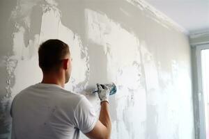 Builders glue white wallpaper on the wall photo