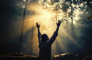 A man praying in a rays of light scene - photo