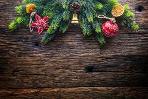 Christmas. Christmas decoration fir tree with star jingle bell and  pine cone on rustic wooden table photo