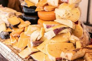 Assortment of cheeses of various textures and colors for sale by a street vendor photo
