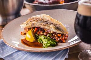 Fillet of zander with vegetables on a plate in a restaurant photo