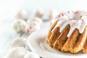 Festive easter marble cake with icing sugar with hand-decorated eggs photo