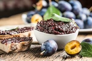 Breakfast from homemade plum jam bread and ripe plums. photo