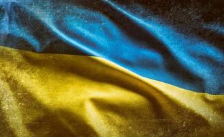 Ukrainian flag with concrete background blowing in the wind photo