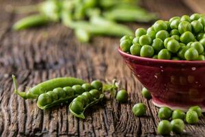 Peas. Fresh bio homemade peas and pods on old oak board. Healthy fresh green vegetable - peas and pods. photo