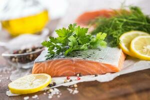 Raw salmon fillet with dill lemon olive oil salt and pepper photo