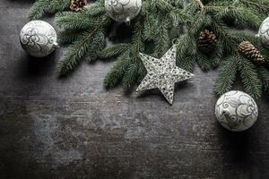 Top of view christmas balls fir tree pine cones on free concrete background photo