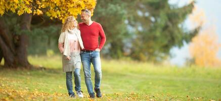 Partners having a walk in the nature on a sunny autumn day photo