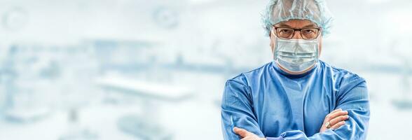 Doctor surgeon specialist looks concentrating. In the background blurred the interior of the operating room photo